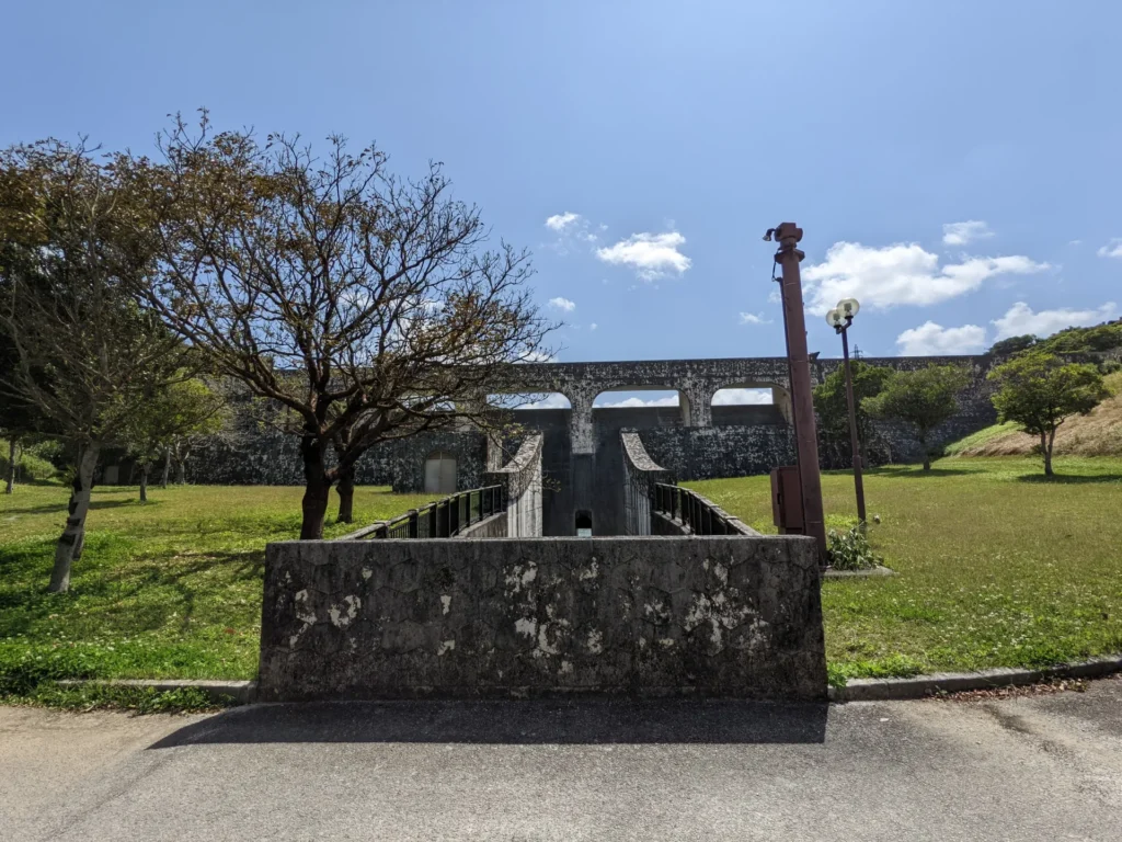 琉球石灰岩で装飾された金城ダムの堰堤と公園広場