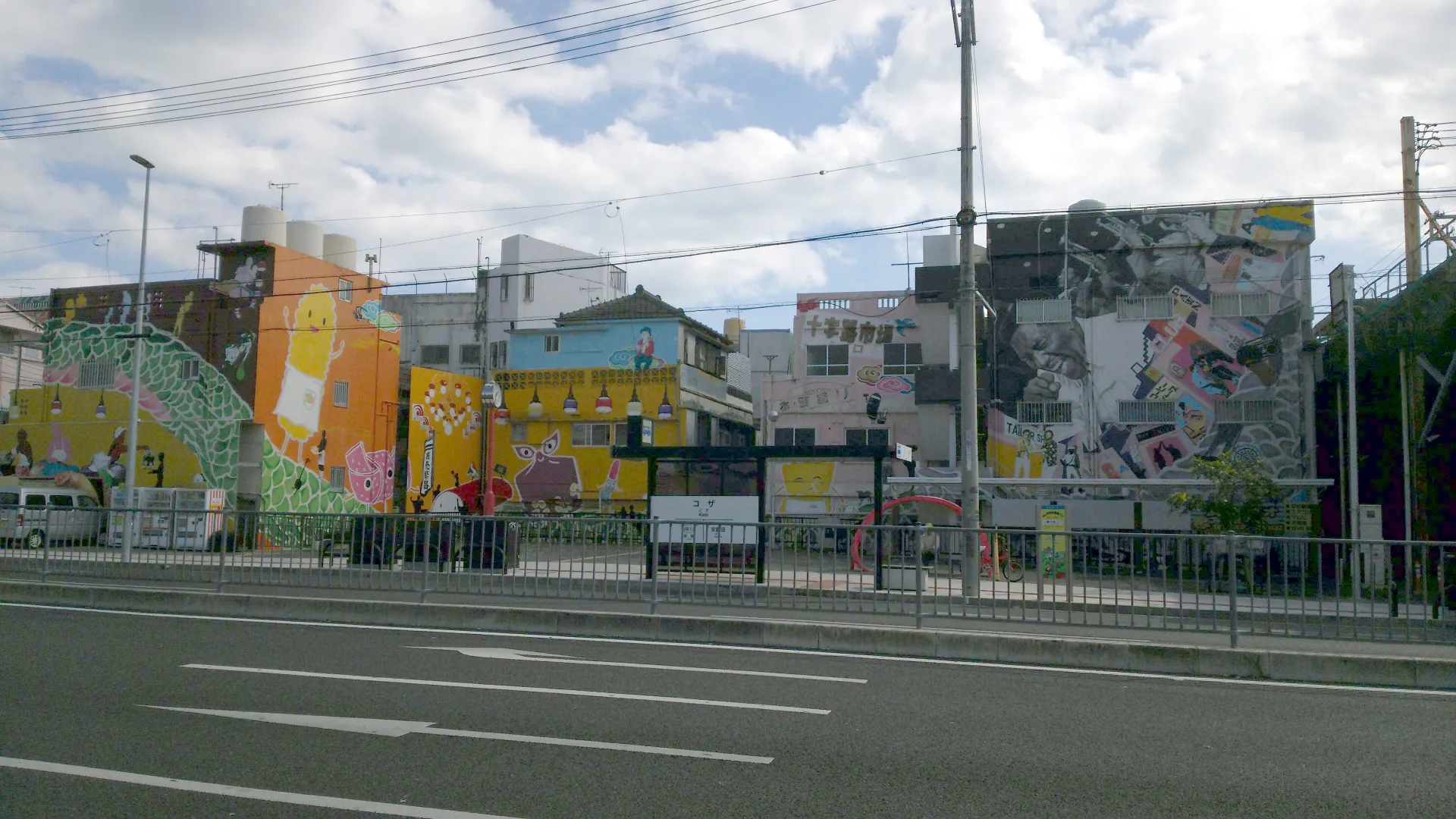 コザ十字路歴史絵巻の壁画。十字路市場とマスコットキャラクターのプーラくん